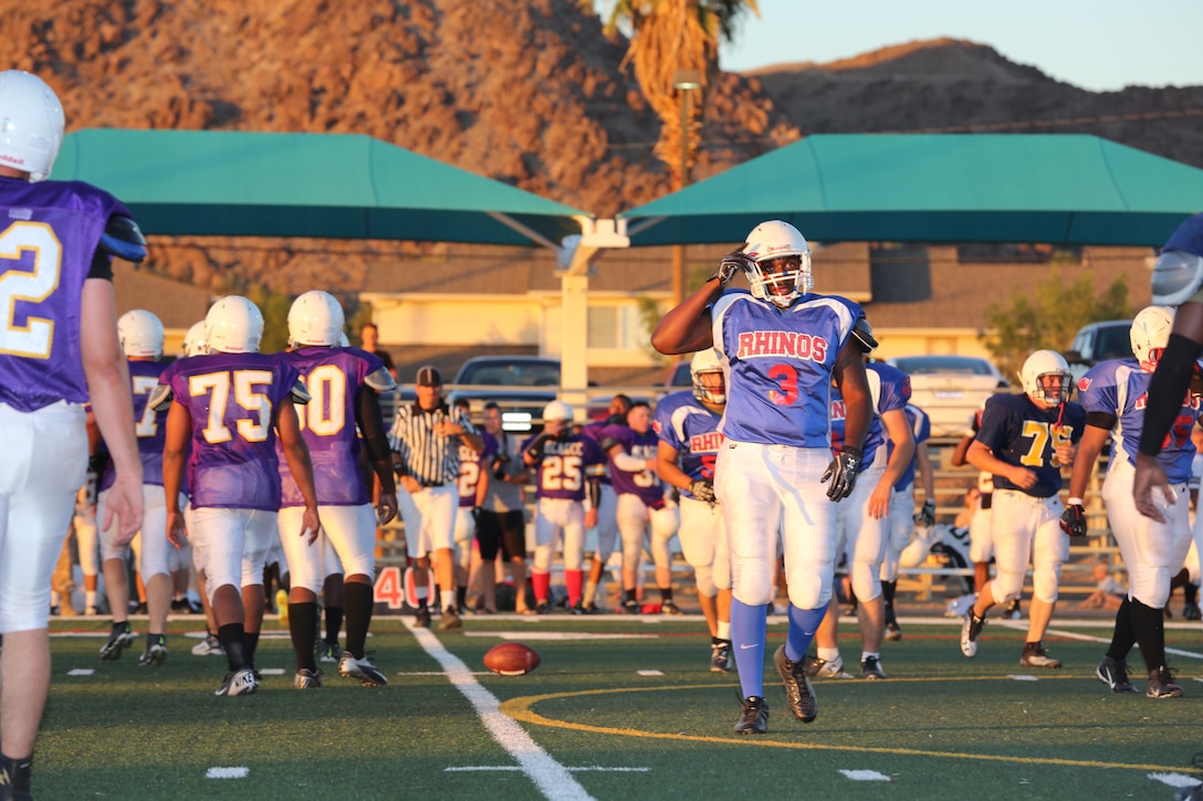 Sgt. Martez McDuffie, embarkation specialist, Marine Wing Support Squadron 374, begins walking off the field after a turnover during the Preseason Jamboree at Felix Field, Aug. 27, 2014. 