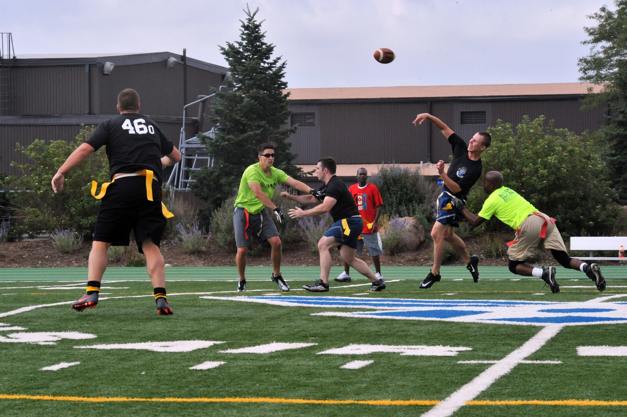 A 460th flag football team member throws the ball during a flag football game at the Tri-Wing Sports Challenge Aug. 27, 2014, at Peterson Air Force Base, Colo. More than 100 Team Buckley members traveled to Peterson Air Force Base to compete and support the Panthers during the games. (U.S. Air Force photo by Airman Emily E. Amyotte/Released)