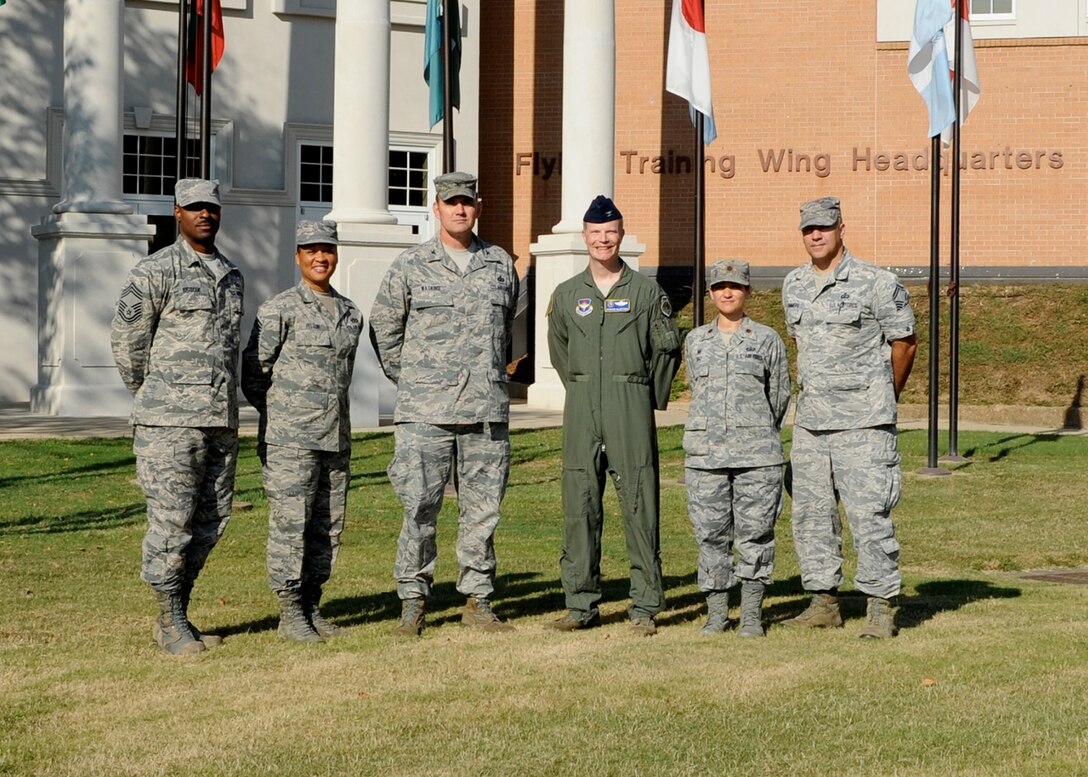 Col. Trae Watkins, Air Education and Training Command’s Financial Management Director, and Chief Master Sgt. Kendall Briscoe, FM Enlisted Functional Manager, pose for a photo with Col. Howard MacArthur, 14th Flying Training Wing Vice Commander, Chief Master Sgt. Rita Felton, 14th Flying Training Wing Command Chief, Maj. Leria Diaz, 14th Comptroller Squadron Commander, and Chief Master Sgt. David Sommers, 14th Comptroller Squadron Superintendent. 