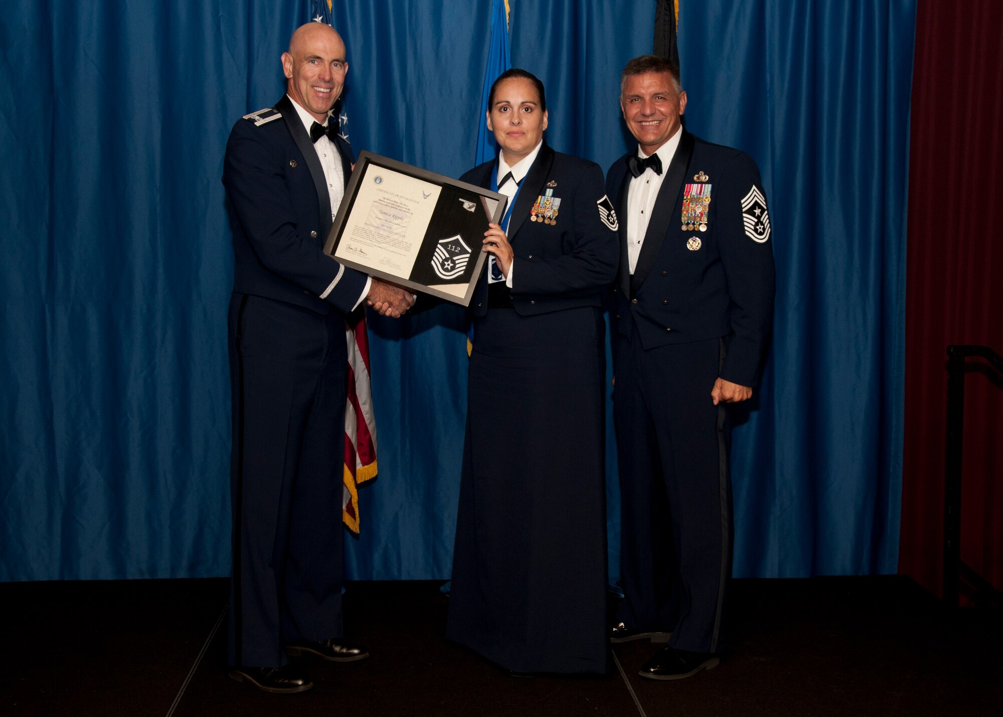 VANCE AIR FORCE BASE, Okla. – Master Sgt. Tamica Rippke, the 71st Comptroller Squadron quality assurance manager, receives set of master sergeant stripes with her line number from Col. Clark Quinn, the 71st Flying Training Wing commander, and Chief Master Sgt. Peter Speen, the 71st FTW Command Chief, Aug. 28 during a Senior NCO-Recognition Ceremony at the Vance Collocated Club. (U.S. Air Force photo/Staff Sgt. James Bolinger)