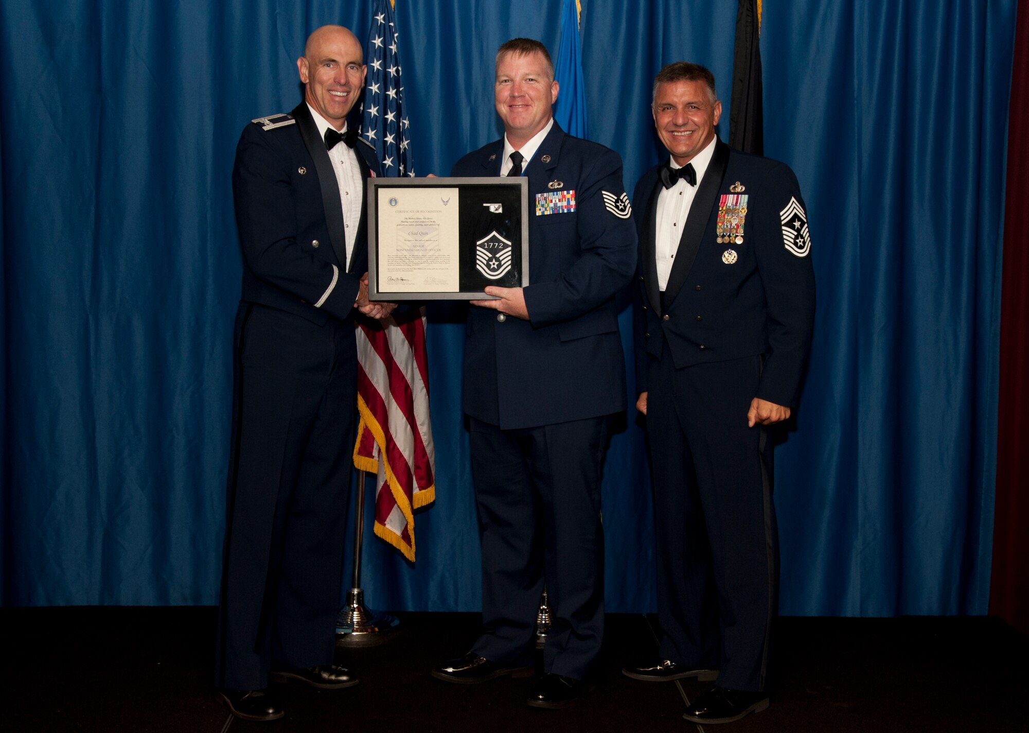 VANCE AIR FORCE BASE, Okla. – Tech. Sgt. Chad Quin, the 71st OSS weather station flight chief, receives set of master sergeant stripes with his line number from Col. Clark Quinn, the 71st Flying Training Wing commander, and Chief Master Sgt. Peter Speen, the 71st Flying Training Wing Command Chief, Aug. 28 during a Senior NCO-Recognition Ceremony at the Vance Collocated Club. (U.S. Air Force photo/Staff Sgt. James Bolinger)