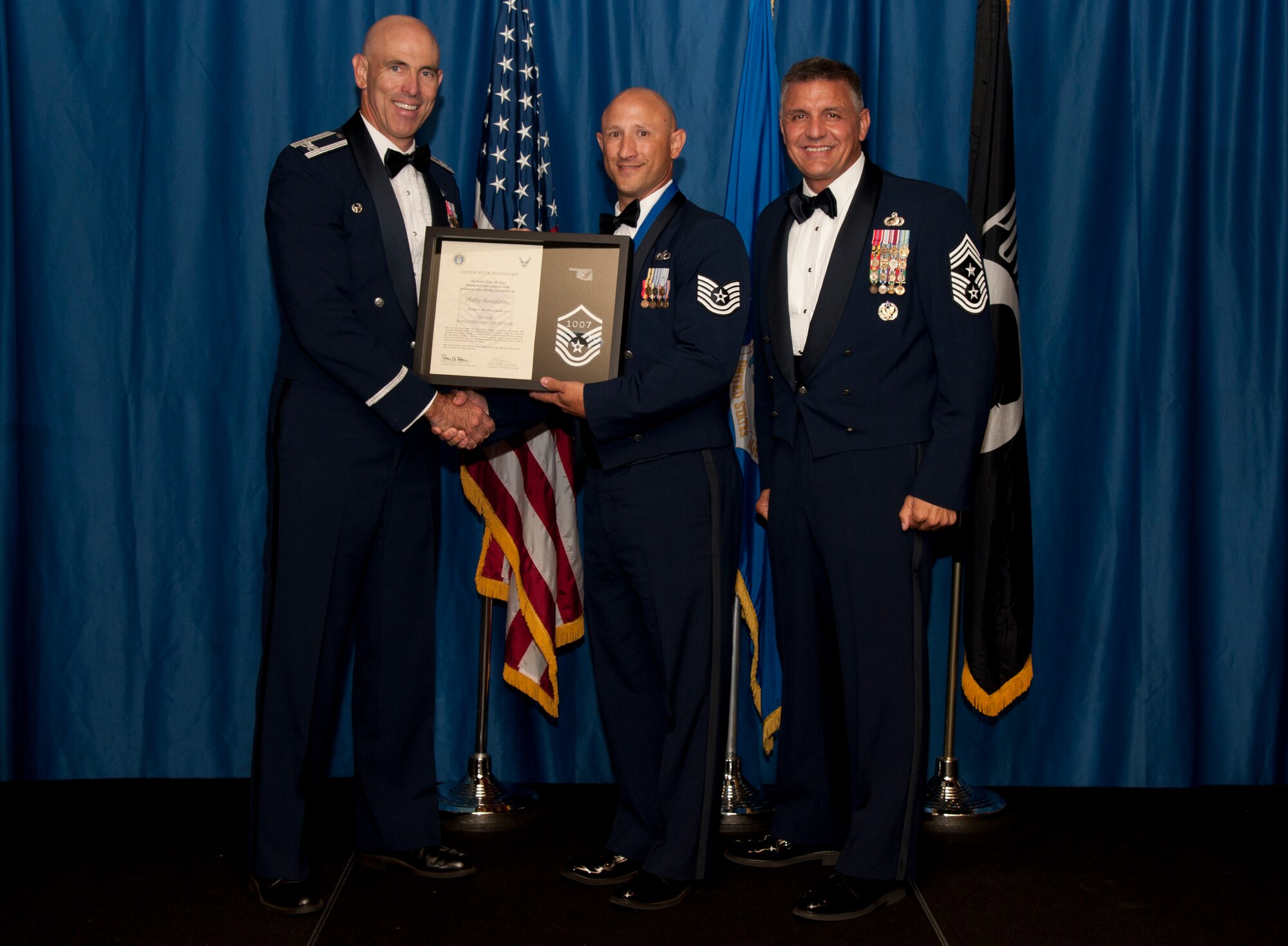 VANCE AIR FORCE BASE, Okla. –Then technical sergeant, now Master Sgt. Philip Bonadonna, the 71st Operations Support Squadron Air Traffic Control RAPCON watch supervisor, receives set of master sergeant stripes with his line number from Col. Clark Quinn, the 71st Flying Training Wing commander, and Chief Master Sgt. Peter Speen, the 71st FTW Command Chief, Aug. 28 during a Senior NCO-Recognition Ceremony at the Vance Collocated Club. (U.S. Air Force photo/Staff Sgt. James Bolinger)