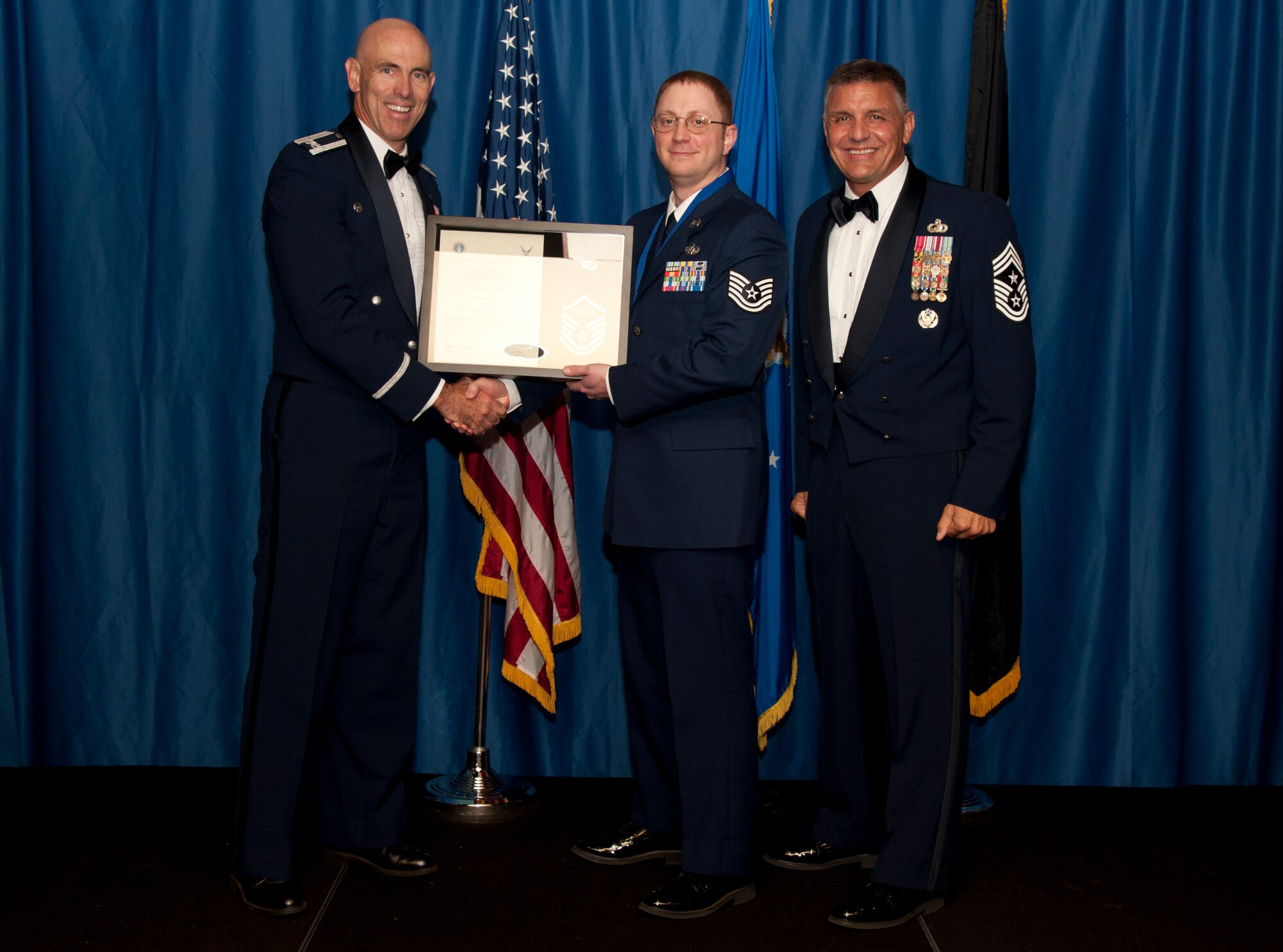 VANCE AIR FORCE BASE, Okla. –Tech. Sgt. Nicholas Barr, the 71st Communications Flight chief contracting officer, receives set of master sergeant stripes with his line number from Col. Clark Quinn, the 71st Flying Training Wing commander, and Chief Master Sgt. Peter Speen, the 71st FTW Command Chief, Aug. 28 during a Senior NCO-Recognition Ceremony at the Vance Collocated Club. (U.S. Air Force photo/Staff Sgt. James Bolinger)
