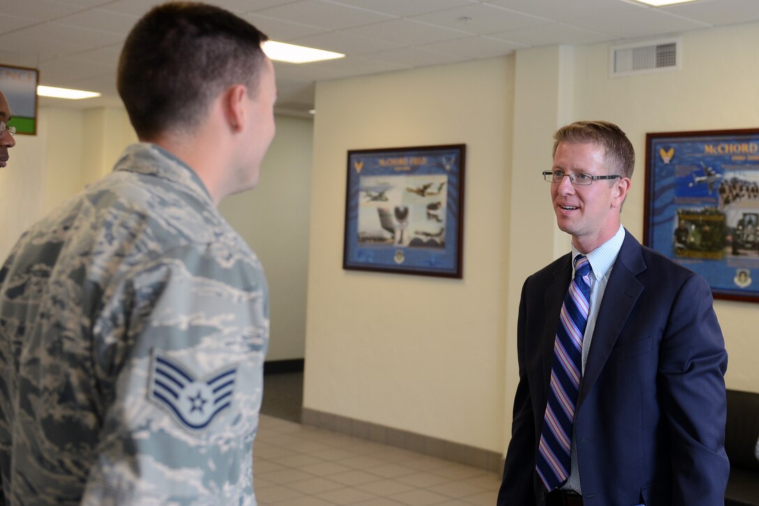 Congressman Derek Kilmer talks with Staff Sgt. Martin Hensen, 62nd Airlift Wing command chief executive assistant, during a base visit Sept. 2, 2014, at Joint Base Lewis-McChord, Wash.  During his visit Kilmer, met with Washington residents and outstanding performers Hensen and Staff Sgt. Samuel Colemen, 62nd AW command chief executive assistant. (U.S. Air Force photo/Airman 1st Class Jacob Jimenez)     