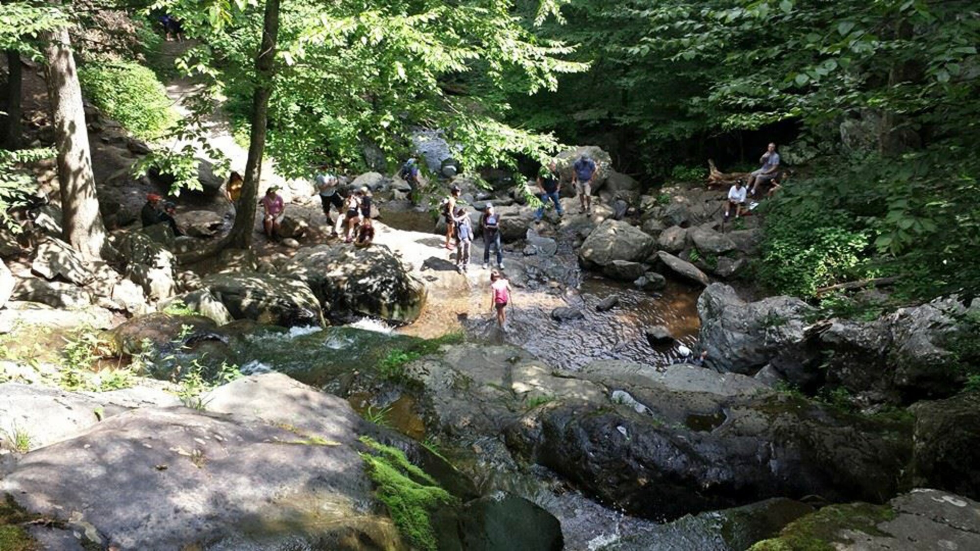 A dozen Airmen and family members from the 89th Communications Squadron rest during a hike at Shenandoah National Park, Va., Aug. 10. Later that day, a Virginia man fell about four feet and smash his head on a boulder. 89th CS airborne communications technicians Airman 1st Class Andrew Pranzo and Tech. Sgt. Jeffery Boyette, and Karen Boyette, treated a Y-shaped gash in the man’s forehead using Pranzo’s shoelace and a pair of shorts from a small child’s diaper bag. Pranzo then assisted the man in a two-mile walk out of the mountains while carrying his young granddaughter. (Courtesy photo)
