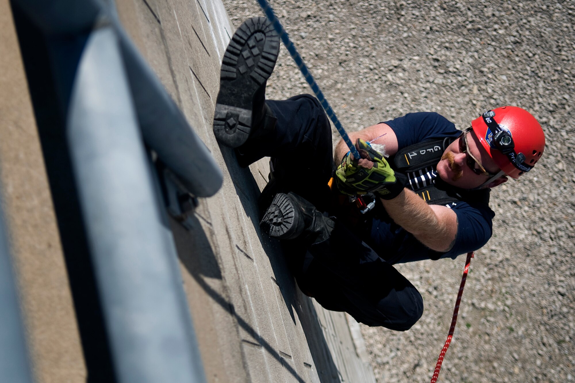 Jamie Lay, Grissom Fire Department firefighter, hangs upside down on a fire training tower at Grissom Air Reserve Base, Ind., Aug. 15, 2014. More than a dozen of the GFD's 49 firefighters are certified rescue trained, allowing them to conduct rescues from high angles, low angles, in confined spaces and from under collapsed structures. (U.S. Air Force photo/Tech. Sgt. Mark R. W. Orders-Woempner) 
