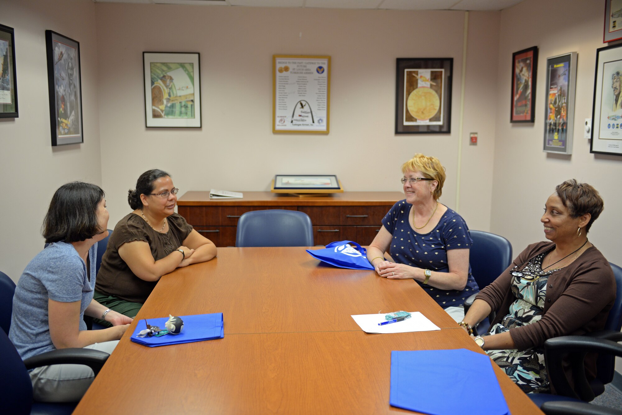 Liz Carpenter, Michelle Franks, Susan Fowler and Erika Huerta-Garlington discuss their favorite recently read books during the monthly book discussion group at the library, Scott Air Force Base, Ill., Aug. 27, 2014. They talked through questions they have about the book and analyze the topic, through sharing personal experiences and opinions, they have the opportunity to see how others may feel about the book. The book they discussed this month was 'The Reason I Jump' by Naoki Higashida, which is a memoir from a Japanese autistic boy. Next month's book is 'The Kitchen House' by Kathleen Grissom. (U.S. Air Force photo by Airman 1st Class Erica Crossen)