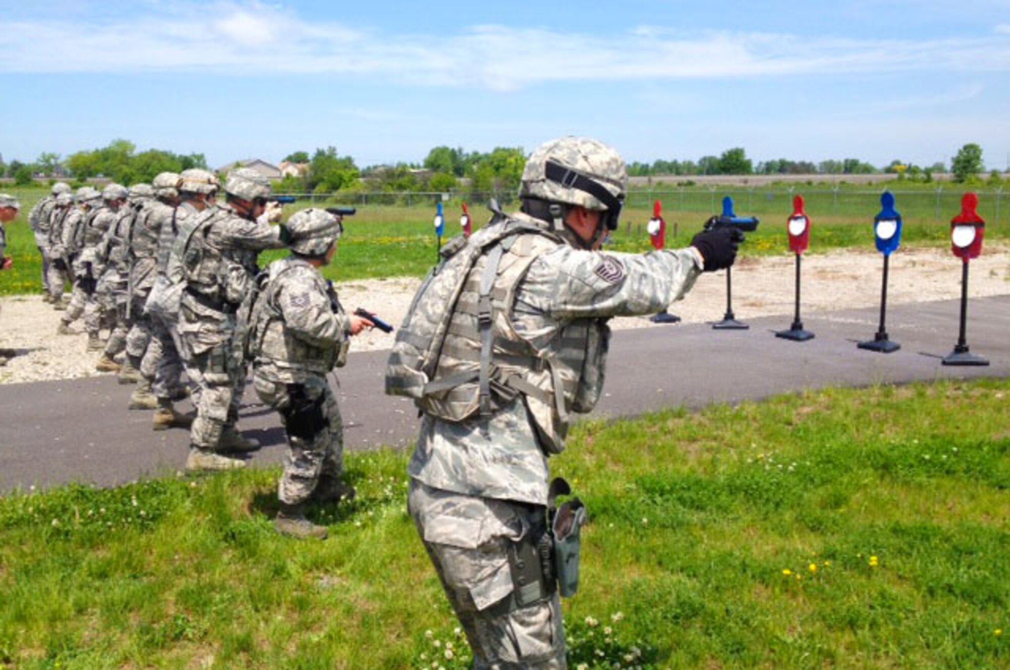 Members of the 914th Security Forces Squadron practice firing techniques at Niagara Falls Air Reserve Station on June 9, 2014. Personnel were utilizing the Combat Pistol Course here. (U.S. Air Force photo by 1st Lt. Brian Rhoney)