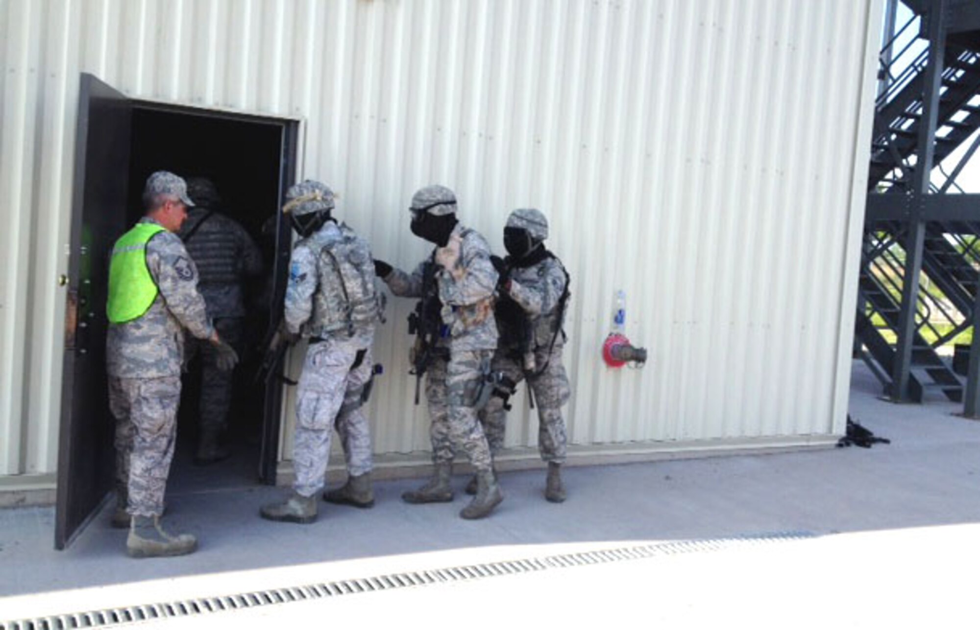 Members of the 914th Security Forces Squadron demonstrate breaching procedures at Niagara Falls Air Reserve Station on June 9, 2014. Personnel were participating in an active shooter exercise here. (U.S. Air Force photo by 1st Lt. Brian Rhoney)