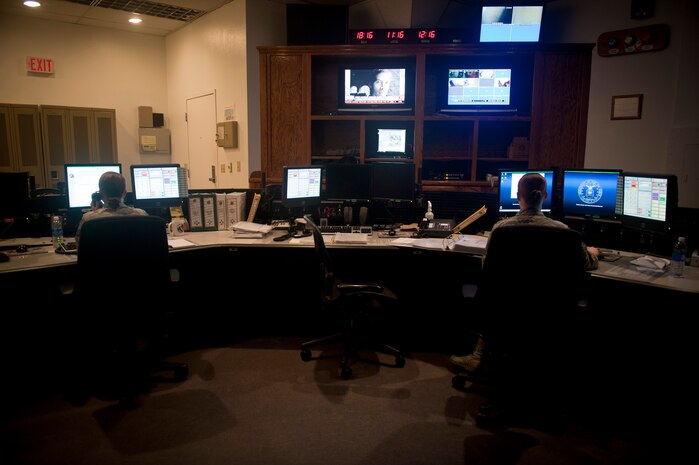 Tech. Sgt. Laura Langley (left) and Senior Airman Sarah Myers, 99th Air Base Wing Command Post senior and junior controllers, field phone calls at their workstations at Nellis Air Force Base, Nev., Aug. 21, 2014. Command post controllers are the ‘eyes and ears’ of Nellis and Creech AFBs, and constantly monitor interactions occurring on both installations. (U.S. Air Force photo by Staff Sgt. Siuta B. Ika)