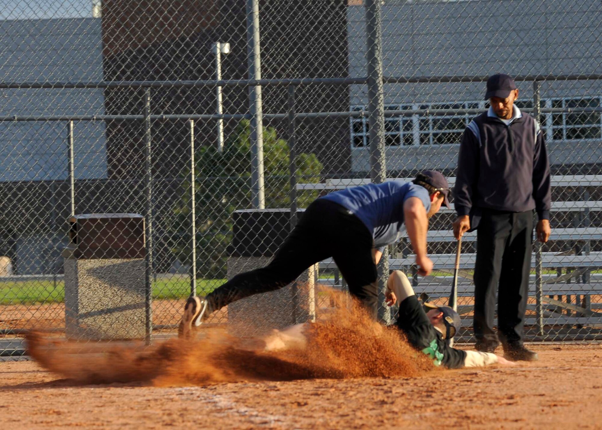 PETERSON AIR FORCE BASE, Colo. -- Staff Sgt. Ryan Sison, 21st Comptroller Squadron, slides into home plate during the first of two games against NORAD NORTHCOM Aug. 28 in the base softball championship. The 21st Space Wing Staff team went undefeated the entire season, however, the 21st WSA team lost game one of the championship, which forced a second game. In the second game the 21st WSA team defeated the NORAD team to claim the title. (U.S. Air Force photo/Airman 1st Class Rose Gudex)