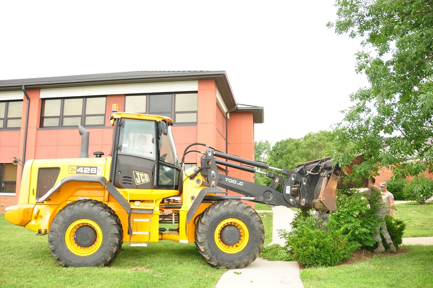 932nd Airlift Wing civil engineers used heavy equipment for training and removed overgrowth and various debris around the headquarters building to help beautify the area.  (U.S. Air Force photo/Maj. Stan Paregien)