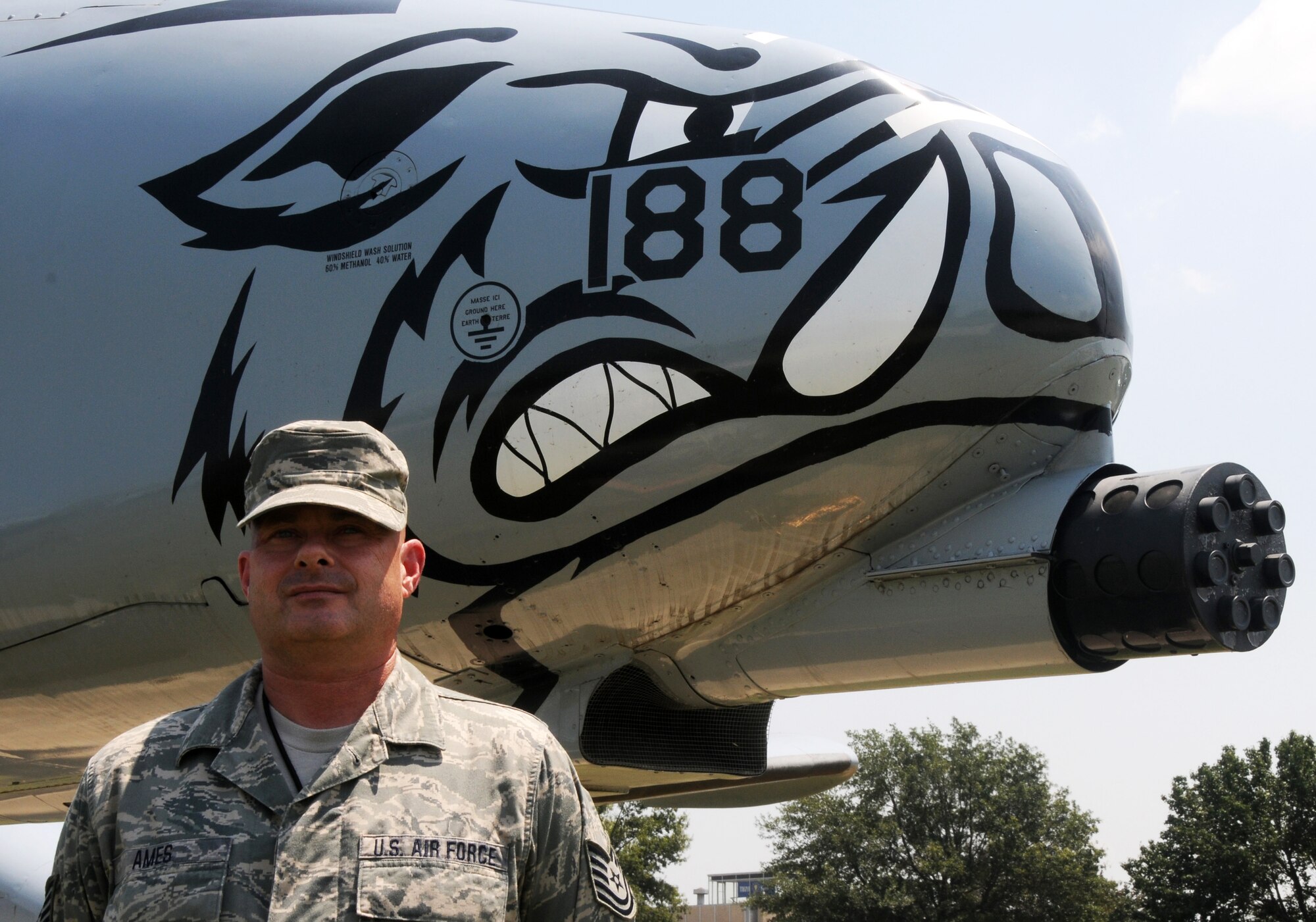 Tech. Sgt. Jeffery Ames poses in front of an A-10C Thunderbolt II, "Warthog", at the 188th Wing, Ebbing Air National Guard Base, Fort Smith, Arkansas, Aug. 3, 2014. Ames is assigned to the 153th Intelligence Squadron and was selected as The Flying Razorback spotlight for September 2014. (U.S. Air National Guard photo by Airman 1st Class Cody Martin/released)