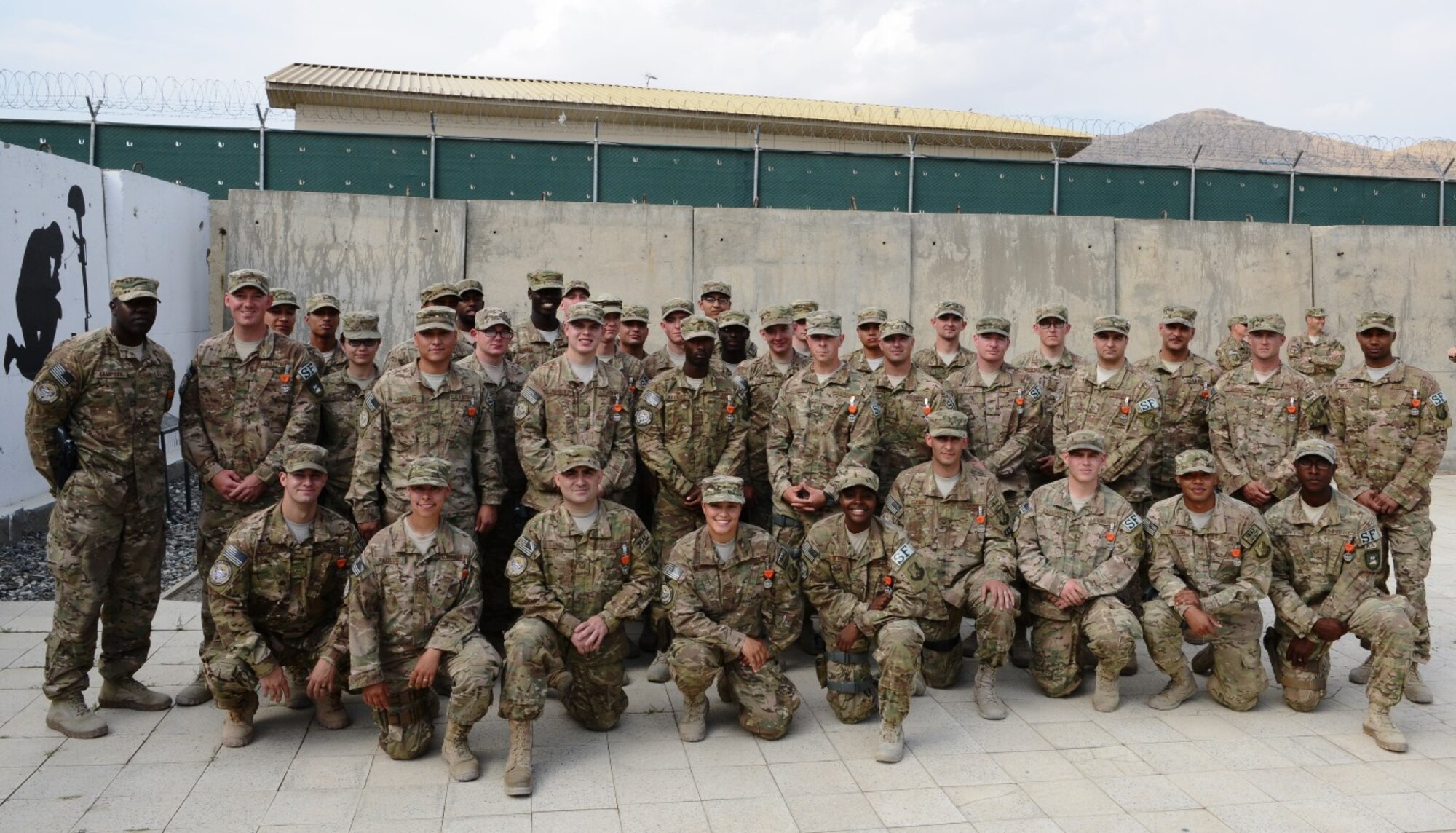 Members of the 439th Air Expeditionary Advisory Squadron security forces pose for a photo just afer receiving Air Force Combat Action Medals during a ceremony at Forward Operating Base Oqab, Kabul, Afghanistan, Sept. 2. The Airmen were recognized for actions defending FOB Oqab, the Kabul Air Wing of the Afghan Air Force, and Kabul International Airport from a complex attack featuring rocket propelled grenades, small arms and automatic gunfire July 17, 2014. (U.S. Air Force photo/Senior Master Sgt. Mike Hammond)