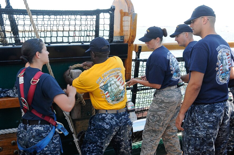 Tech. Sgt. Marissa A. Cross, 66th Comptroller Squadron Accounting Support Flight NCO in charge, participates in a Boston Harbor turn-around on board the U.S.S. Constitution ship in Boston Aug. 29. Cross and Tech. Sgt. Jessica S. LaBrie, Battle Management Directorate Operations Management NCO in charge, attended the Navy’s Chief Petty Officer Heritage Week Aug. 25 through 29. The two NCOs spent the week learning time-honored maritime traditions such as boarding drills, gun drills and other Navy traditions. (U.S. Air Force photo by Linda LaBonte Britt)