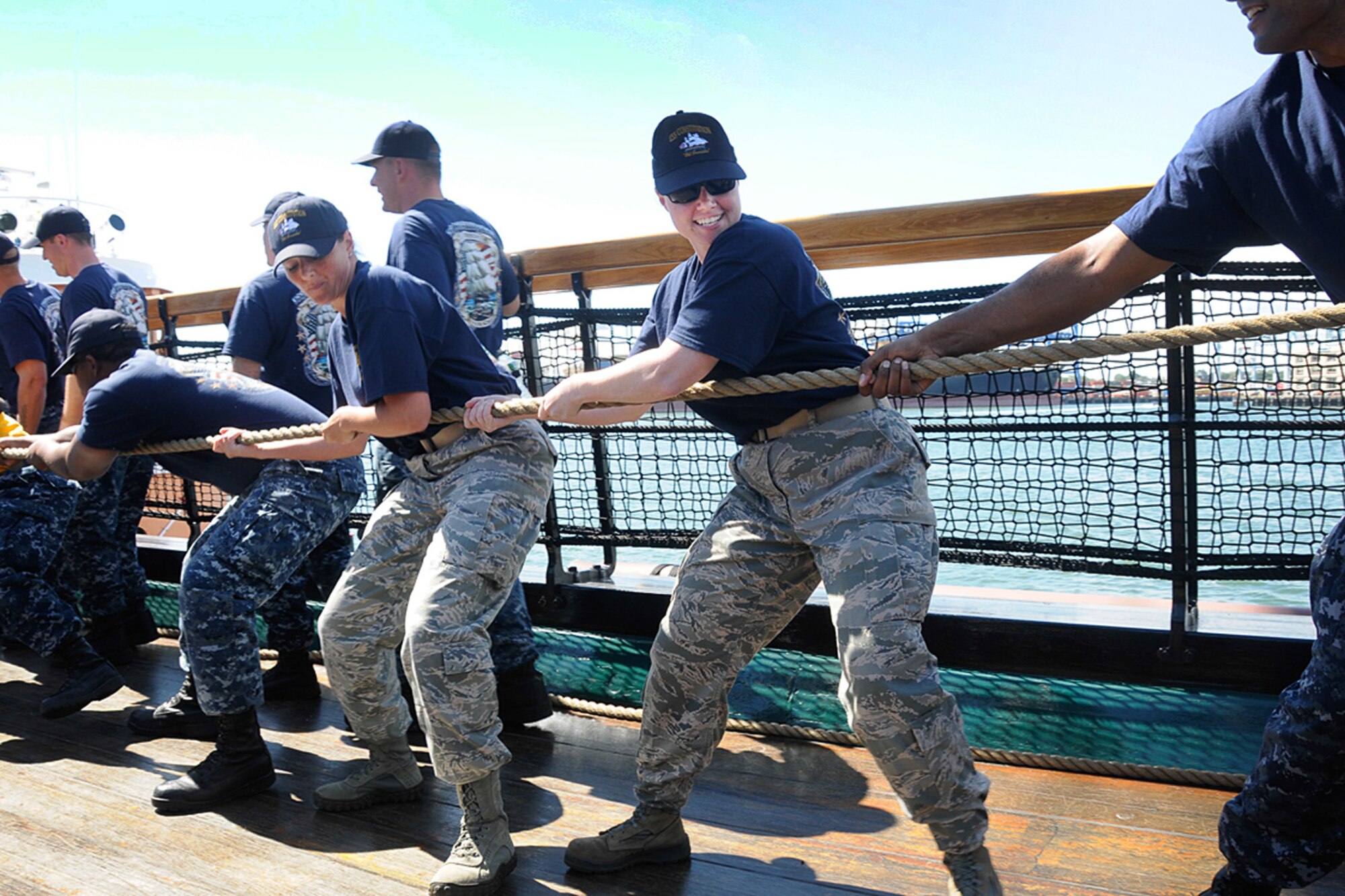 Tech. Sgt. Marissa A. Cross (left), 66th Comptroller Squadron Accounting Support Flight NCO in charge, and Tech. Sgt. Jessica S. LaBrie (right), Battle Management Directorate Operations Management NCO in charge, participates in a Boston Harbor turn-around on board the U.S.S. Constitution ship in Boston Aug. 29. Cross and LaBrie attended the Navy’s Chief Petty Officer Heritage Week Aug. 25 through 29. The two NCOs spent the week learning time-honored maritime traditions such as boarding drills, gun drills and other Navy traditions. (U.S. Air Force photo by Linda LaBonte Britt)