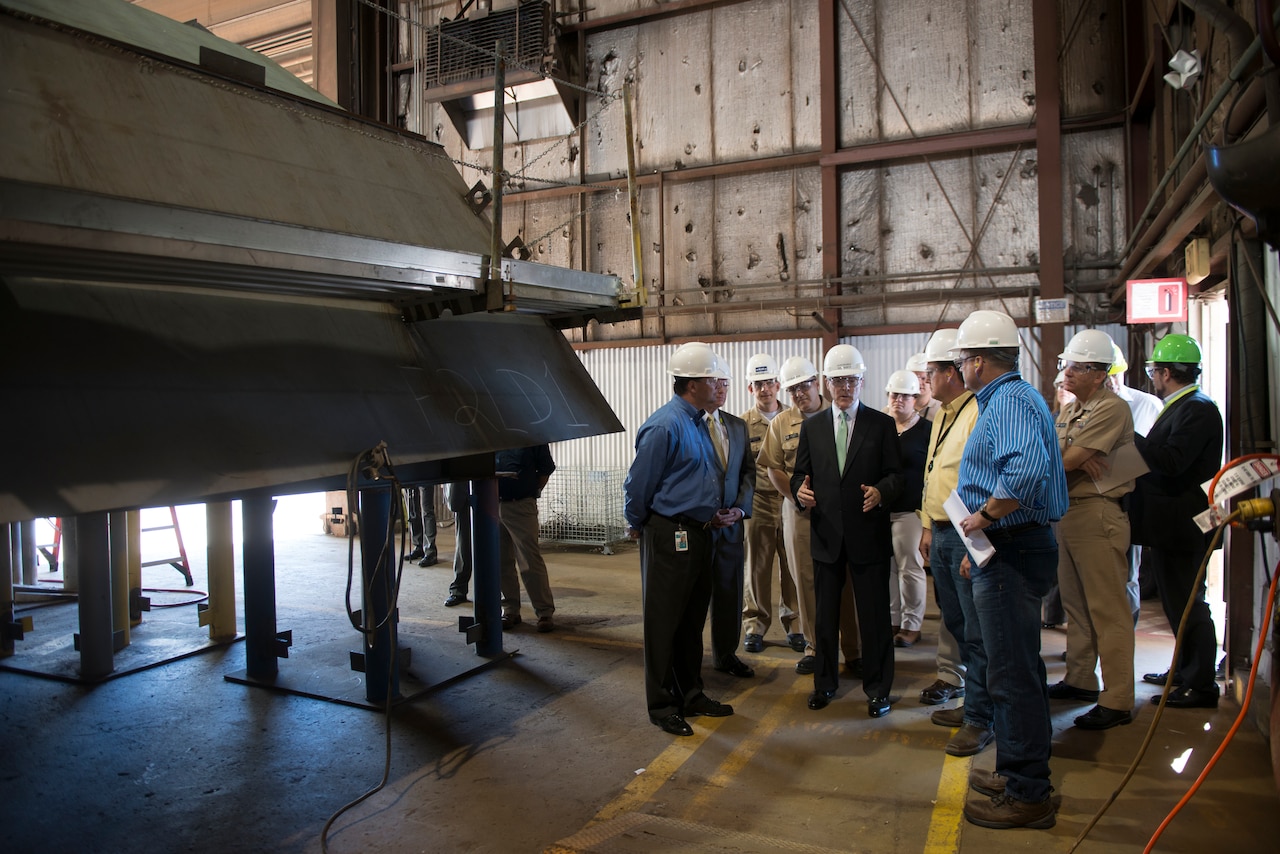 Chief of Naval Operations Adm. Jonathan W. Greenert views the progress made in the construction of multiple Freedom-class littoral combat ships during a tour of the Marinette Marine Corp. shipyard in Marinette, Wis., July 24, 2013. Manufacturing is one of the military career areas targeted for civilian credentialing by a new DoD initiative designed to help separating service members move into the private sector. U.S. Navy photo by Petty Officer 1st Class Peter D. Lawlor