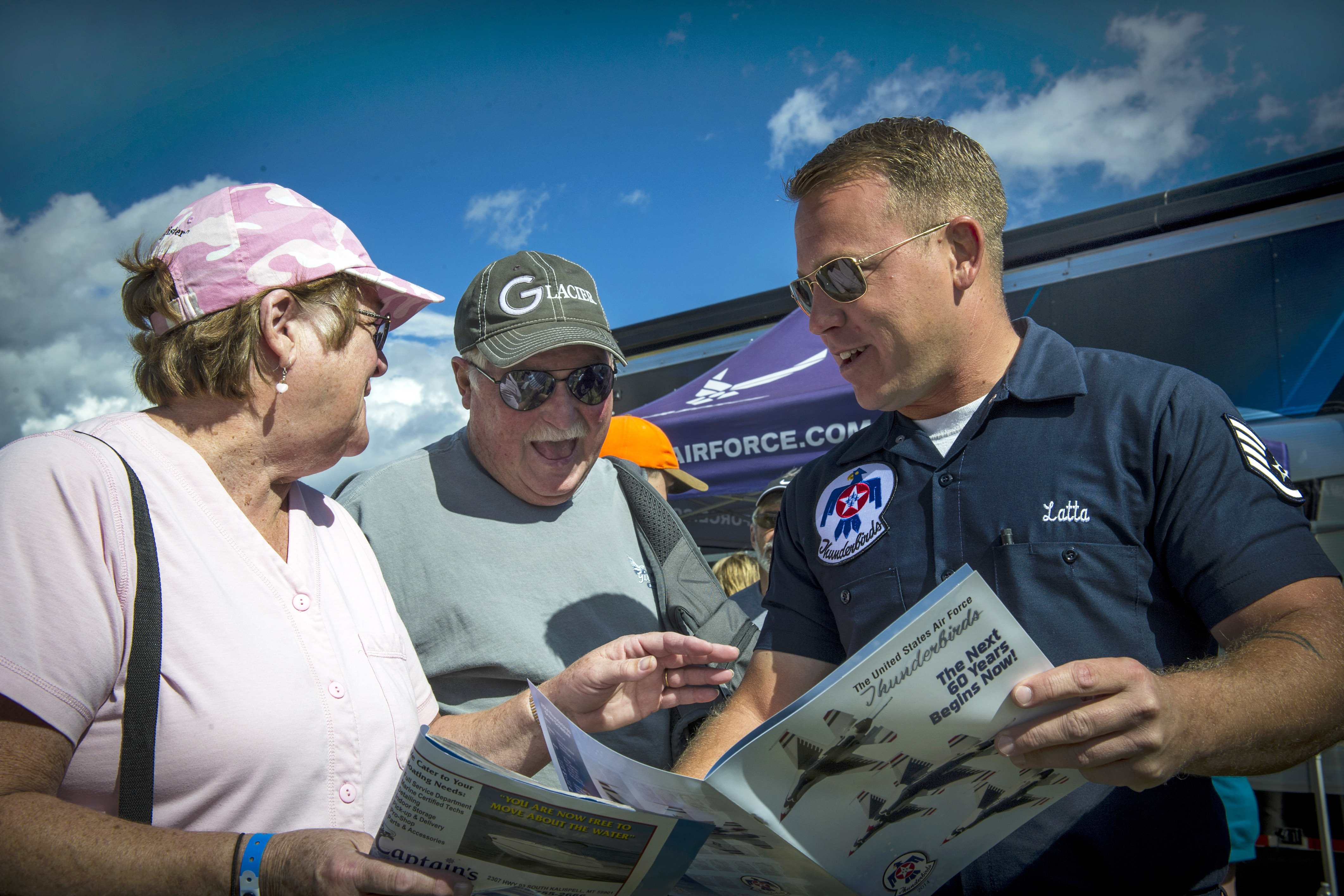 Air Force Staff Sgt. Adam Latta, right, speaks with fans during the ...