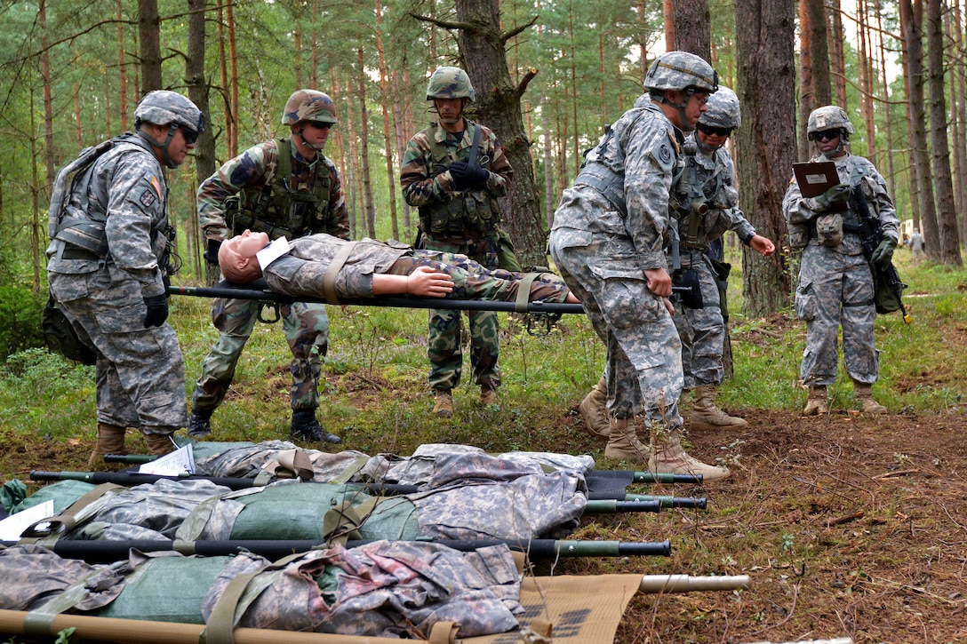 U.S. and Macedonia soldiers evacuate simulated casualties during the U.S. Army Europe Expert Field Medical Badge competition on the Joint Multinational Training Command's Grafenwoehr Training Area, Germany, Aug. 25, 2014.