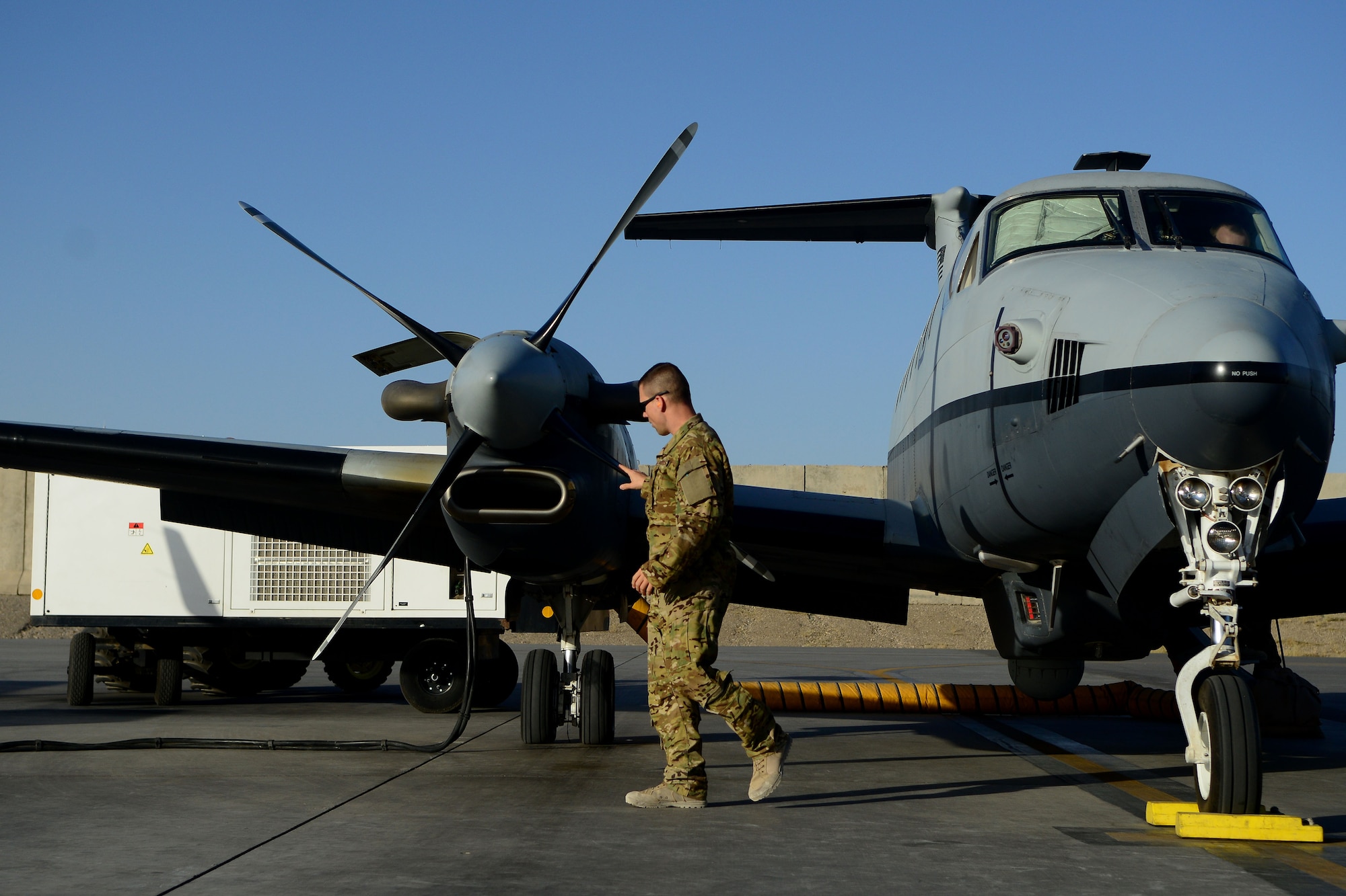An Airman with the 361st Expeditionary Reconnaissance Squadron inspects an MC-12W Liberty Aug. 20, 2014, before a mission at Kandahar Airfield, Afghanistan. The squadron reached its end of mission in September after four years of operations in Afghanistan. (U.S. Air Force photo/Staff Sgt. Evelyn Chavez)