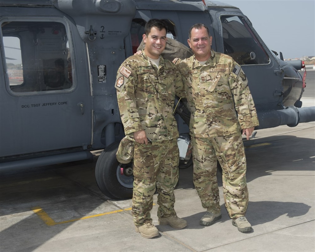 Senior Airman Daniel Ibarra, left, and Chief Master Sgt. Lazaro Ibarra pose in front of a HH-60G Pave Hawk helicopter Aug. 27, 2014, at Camp Lemonnier, Djibouti. The Ibarra’s are a father and son deployed in support of Combined Joint Task Force-Horn of Africa from the 920th Rescue Wing, Patrick Air Force Base, Fla. Daniel is a loadmaster with the 81st Expeditionary Rescue Squadron and Chief Ibarra is a flight engineer with the 303rd ERQS. (U.S. Air Force photo/Staff Sgt. Leslie Keopka) 