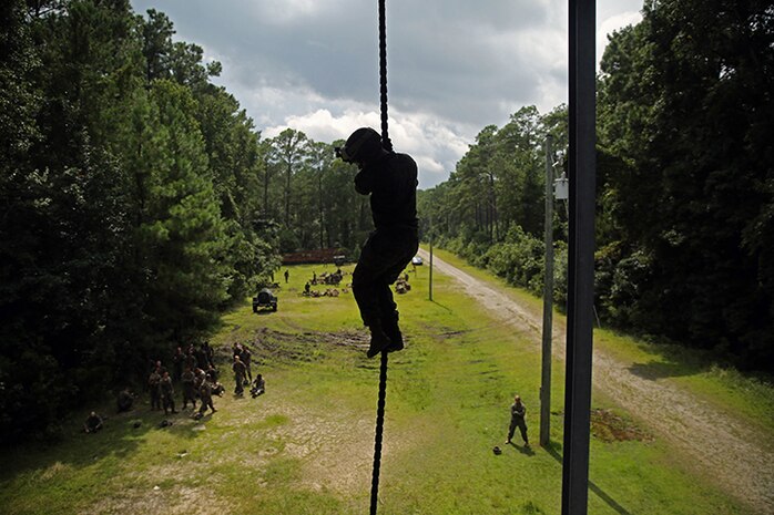 A Marine with Battalion Landing Team 3rd Battalion, 6th Marine Regiment, 24th Marine Expeditionary Unit, descends a fast-rope during Fast-Rope Insertion Extraction System qualification at Camp Lejeune, N.C., August 21, 2014. Marines spent two days fast-roping from a tower and an MV-22B Osprey in preparation for their scheduled deployment at the end of the year. (U.S. Marine Corps photo by Sgt. Devin Nichols)
