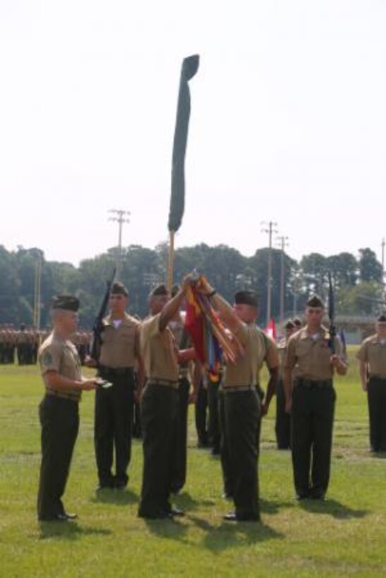 Sergeant Maj. Irvin Howard (center left), the sergeant major of 1st Battalion, 9th Marine Regiment, 2nd Marine Division, and Lt. Col. Corey Collier (center right), the battalion commanding officer, roll and case the battalion’s colors one final time during the unit’s deactivation ceremony aboard Marine Corps Base Camp Lejeune, N.C., Aug. 29, 2014. The colors will be stored at Headquarters Marine Corps until the battalion answer’s the Nation’s call to active service.


