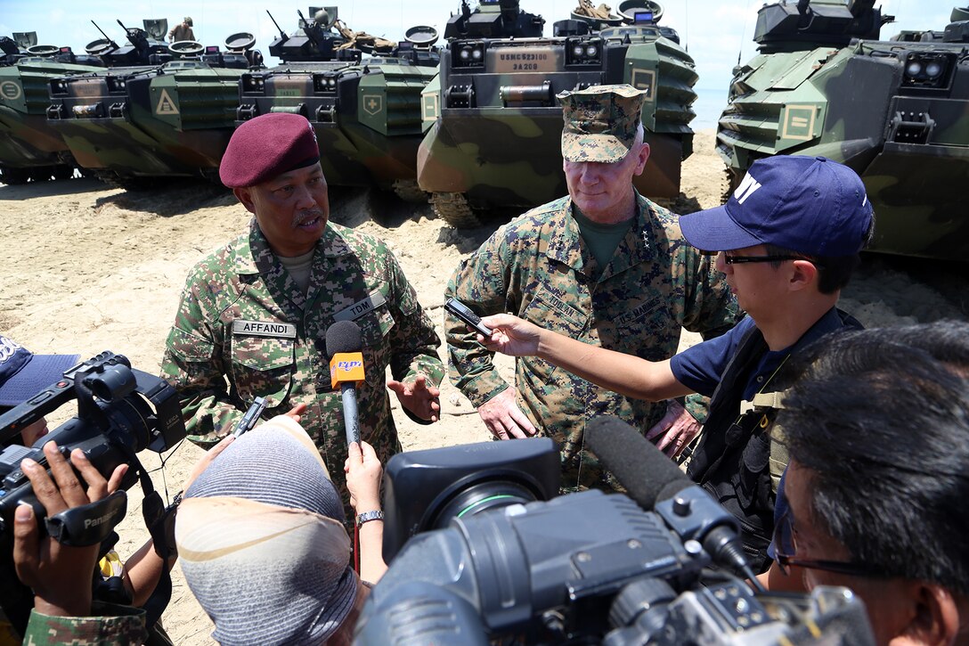 General Tan Sri Raja Mohamed Affandi bin Raja Mohamed Noor, left, Malaysian Chief of Army, and Lt. Gen. John Toolan, commander, U.S. Marine Corps Forces, Pacific, address reporters at a press conference following the closing ceremony of Malaysia-United States Amphibious Exercise 2014 at Kg Tanduo Beach, Malaysia, Sept. 2. MALUS AMPHEX 14 is a bilateral exercise between the 11th MEU and Malaysian Armed Forces that includes operational and tactical level training in planning, command and control, and combat service support using both ground and sea assets. (U.S. Marine Corps photo by Gunnery Sgt. Rome M. Lazarus/Released)