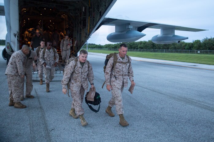 Lt. Col. James S. Whiteker, left, and Sgt. Maj. G. V. Tunnell walk away from a KC-130J Super Hercules upon their arrival on Tinian Aug. 30 for Exercise Valiant Shield 2014. The squadron’s mission during the exercise is to prepare an airstrip and provide support for all participating units. Valiant Shield is a biennial exercise which focuses on the integration of joint training among U.S. forces. Whiteker is the commanding officer of Marine Wing Support Squadron 171, Marine Aircraft Group 12, 1st Marine Aircraft Wing, III Marine Expeditionary Force, and Tunnell is the squadron sergeant major.