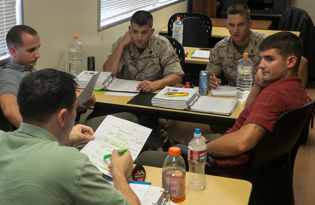 Marines share their opinions on how they believe the sexual assault cases brought before them are related due to similarities found between them at the Education Center, Aug. 21. The Marines attended a class that was designed to teach new investigative techniques to military police and criminal investigators when dealing with sexual assaults. The Marines are criminal investigators with Marine Corps Base Camp Butler, Marine Corps Installations Pacific.