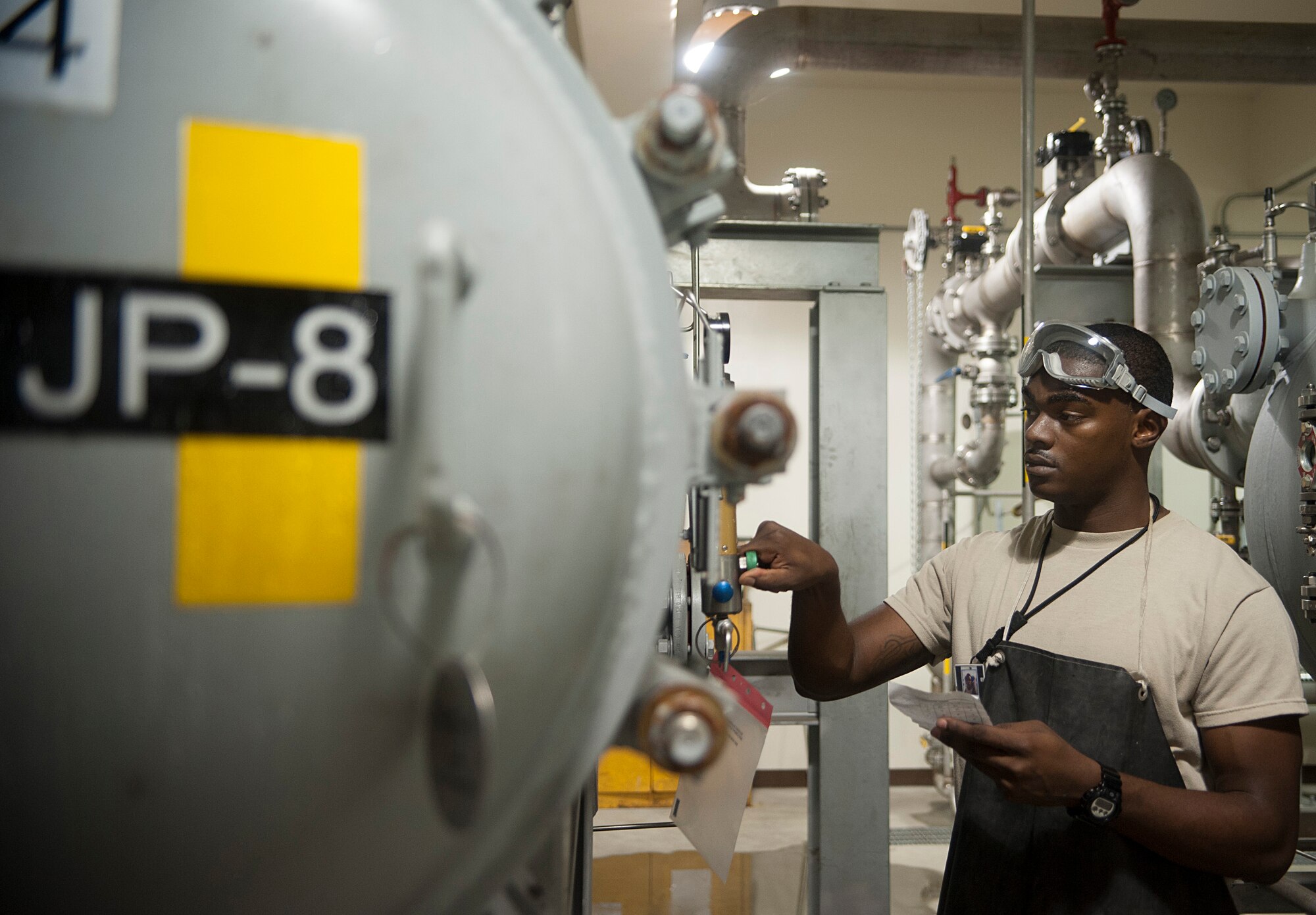 Senior Airman Marcus Middlebrooks, 51st Logistics Readiness Squadron fuel hydrants operator, checks a fuel filter separator at Osan Air Base, Republic of Korea, Aug. 6, 2014. The filter separators can push 2,400 gallons of fuel a minute to make sure it is free of sediments, dirt and water. (U.S. Air Force photo by Senior Airman Matthew Lancaster/Released)