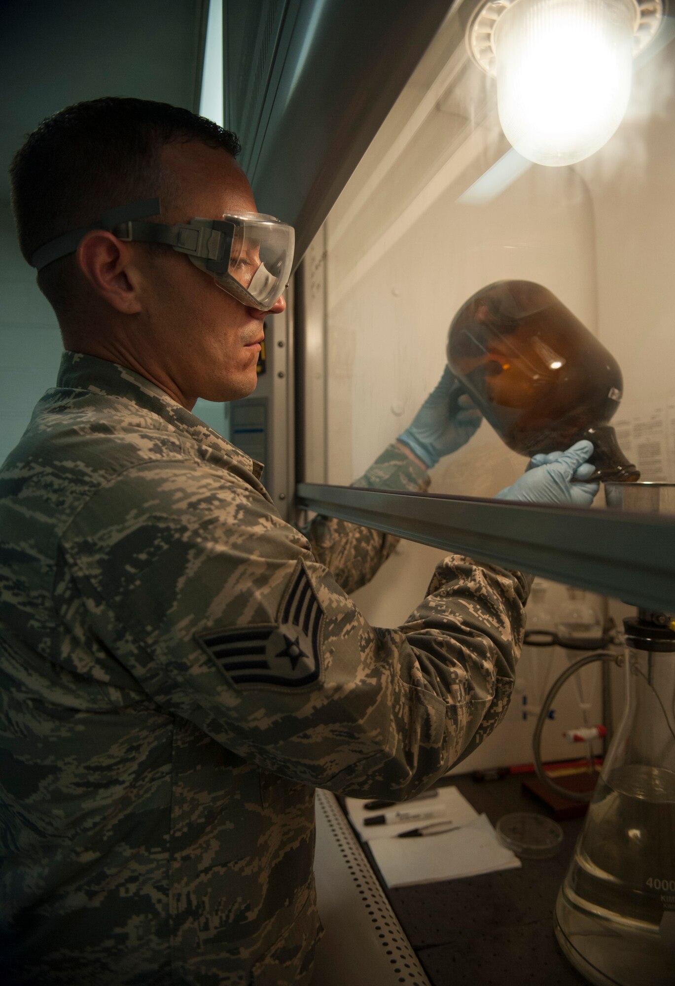 Staff Sgt. Carl Countryman, 51st Logistics Readiness Squadron fuels lab technician, performs a solids contaminates test at Osan Air Base, Republic of Korea, Aug. 5, 2014. The fuels lab makes sure the fuel in the trucks do not contain contaminates that would damage the aircraft. (U.S. Air Force photo by Senior Airman Matthew Lancaster/Released)