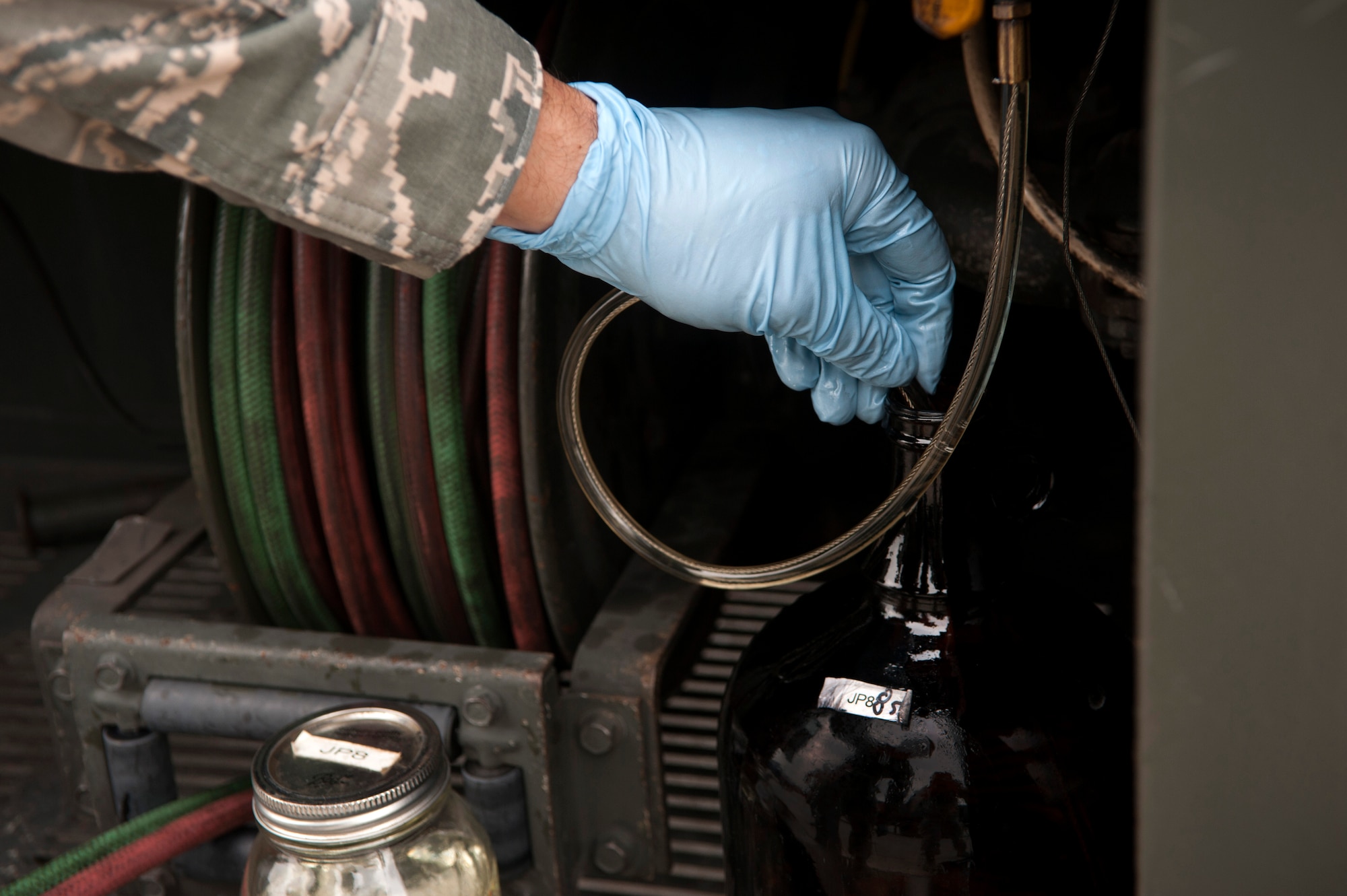Staff Sgt. Carl Countryman, 51st Logistics Readiness Squadron fuels lab technician, takes a fuel sample at Osan Air Base, Republic of Korea, Aug. 5, 2014. The fuels lab would take daily fuel samples to be tested for any contaminates. (U.S. Air Force photo by Senior Airman Matthew Lancaster/Released)