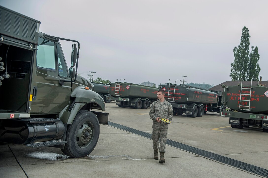 Airman 1st Class Jamie Groseclose, 51st Logistics Readiness Squadron fuels operator, does a safety check on a fuels truck at Osan Air Base, Republic of Korea, Aug. 5, 2014. Before fuel operators go to fuel a jet they would check to make sure the truck is safe to drive. (U.S. Air Force photo by Senior Airman Matthew Lancaster/Released)