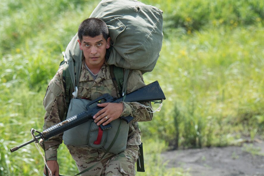 A U.S. Soldier walks to a control point after parachuting out of a C-130 Hercules at Combined Arms Training Center Camp Fuji, Japan, Sept. 3, 2014. The Soldier is with the 1st Battalion, 1st Special Forces Group (Airborne). (U.S. Air Force photo by Osakabe Yasuo/Released) 