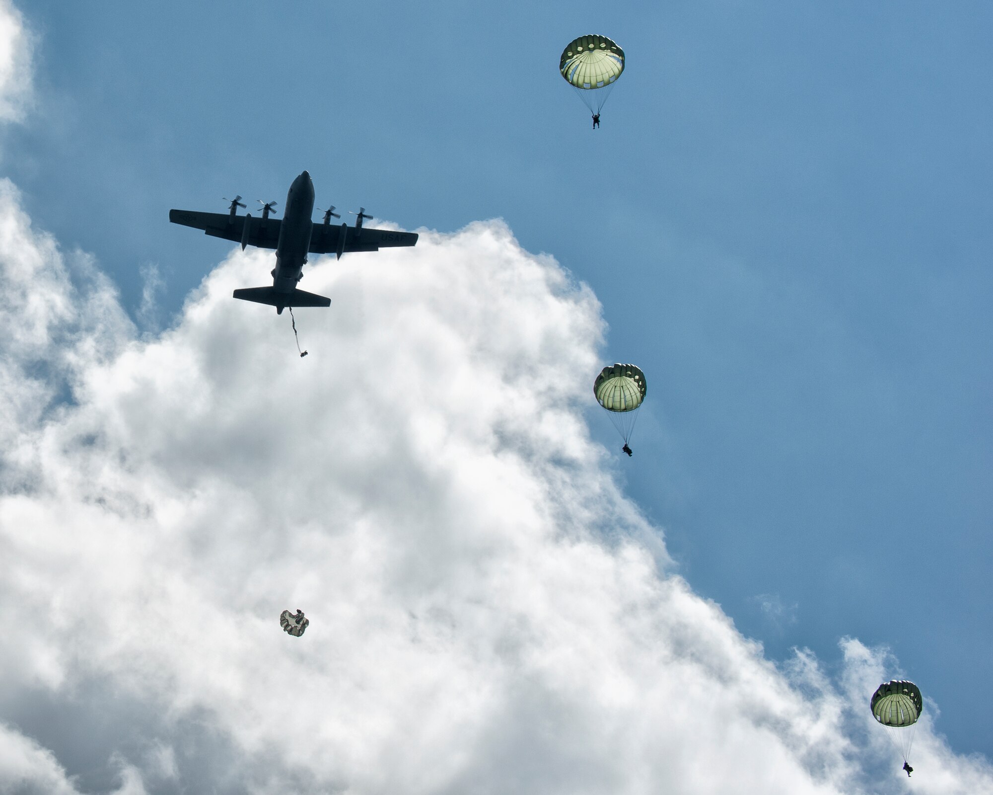 U.S. Soldiers from the 1st Battalion, 1st Special Forces Group (Airborne) conduct a training jump from an Air Force C-130 Hercules, assigned to the 36th Airlift Squadron, at Combined Arms Training Center Camp Fuji, Japan, Sept. 3, 2014.  The training not only allowed the Soldiers to practice jumping, but it also allowed the Yokota aircrews to practice flight tactics and timed-package drops.  (U.S. Air Force photo by Osakabe Yasuo/Released)