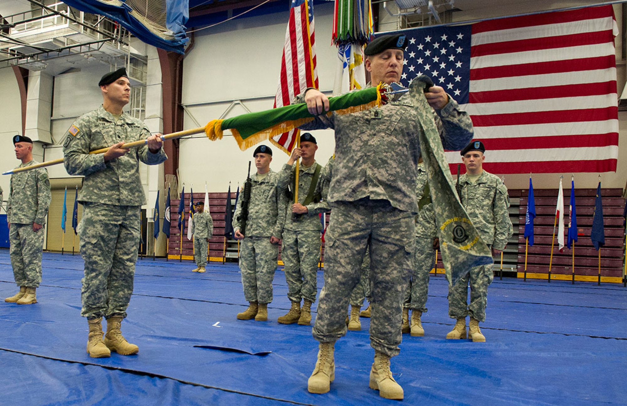 Command Sgt. Maj. Bryan Lynch, right, a native of Mineola, N.Y., cases the battalion colors during the inactivation ceremony for the 793d Military Police Battalion, 2nd Engineer Brigade, at the Buckner Physical Fitness Center, Aug. 28, as the 793d MP battalion commander, Army Lt. Col. Kirt Boston, a native of Lehighton, Pa., holds the colors steady. (U.S. Air Force photo/Justin Connaher)