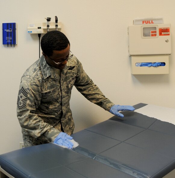 U.S. Air Force Chief Master Sgt. Eddie Webb, 7th Bomb Wing command chief, wipes down a table inside an examination room at the 7th Medical Group Aug. 28, 2014, at Dyess Air Force Base, Texas. As part of Webb’s program, Teach the Chief, he spends an entire day learning a specific career field alongside an Airman who teaches him the job. (U.S. Air Force photo by Airman 1st Class Autumn Velez/Released)