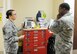 U.S. Air Force Airman 1st Class Elisabeth Celestino, 7th Medical Operations Squadron aerospace medical technician, shows Chief Master Sgt. Eddie Webb, 7th Bomb Wing command chief, a crash cart located in family health Aug. 28, 2014, at Dyess Air Force Base, Texas. Once a month, Webb works side-by-side a junior enlisted Airman learning about his or her specific career field. (U.S. Air Force photo by Airman 1st Class Autumn Velez/Released)