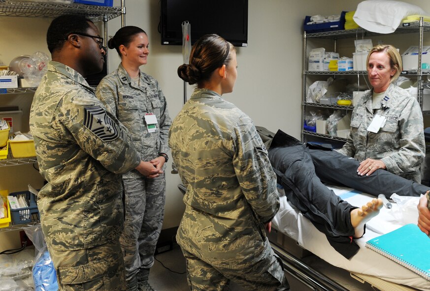 U.S. Air Force Chief Master Sgt. Eddie Webb, 7th Bomb Wing command chief, participates in urinary catheter training led by Capt. Denise Dalton-Love, 7th Medical Group chief of education and training, Aug. 28, 2014, at Dyess Air Force Base, Texas. Webb used this as an opportunity to view hands-on training at the Airman level. As a command chief, Webb is responsible for the professional development, military readiness, training, utilization, health, morale and welfare of all enlisted Airmen in the 7th BW. (U.S. Air Force photo by Airman 1st Class Autumn Velez/Released)