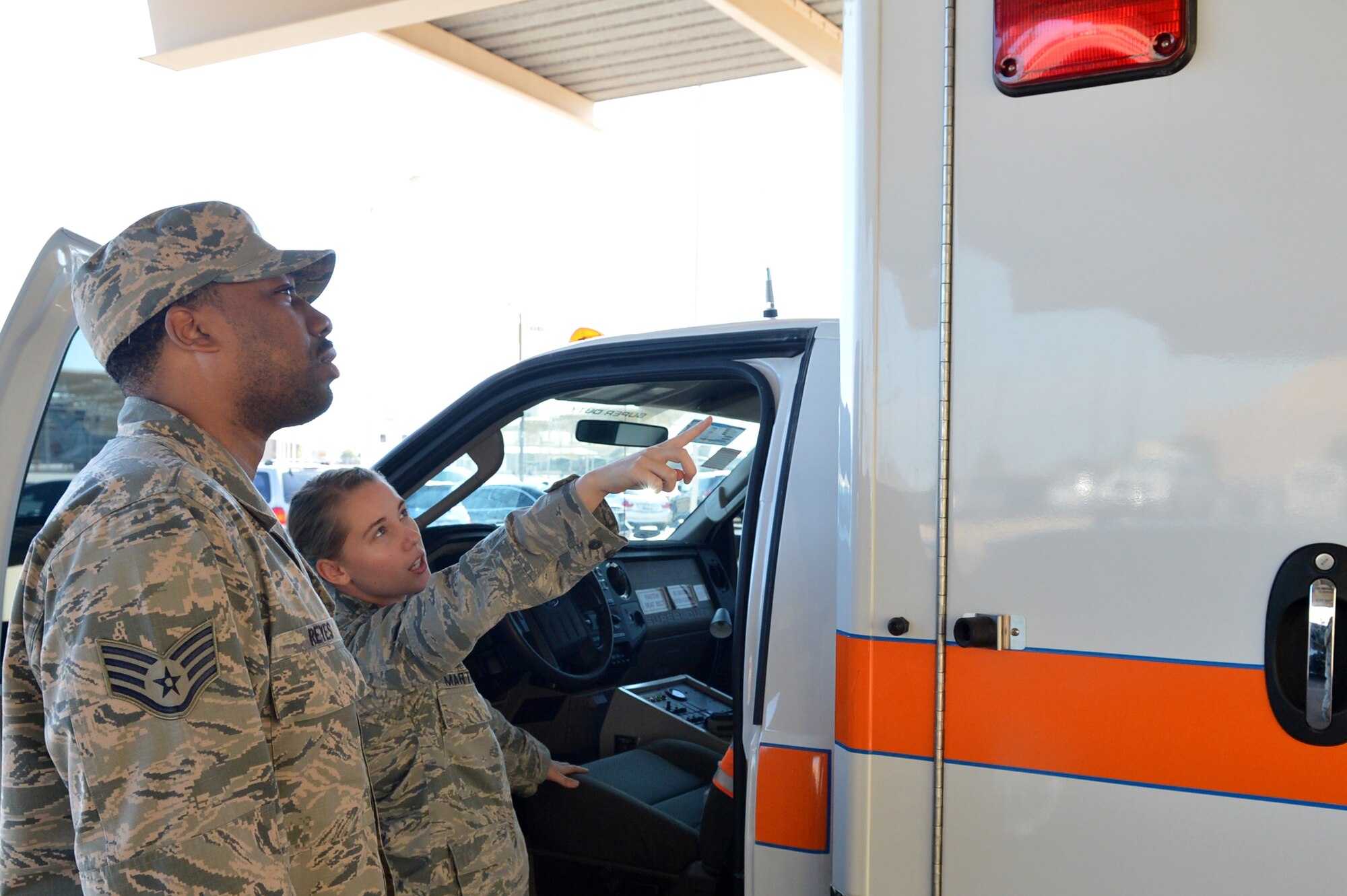 Airman 1st Class Shawn Martinez, 56th Aerospace Medicine Squadron flight medicine technician, checks over the ambulance Aug. 19 with Staff Sgt. Jovanny Reyes, 56th AMDS medical technician, at Luke Air Force Base. Martinez ensures the vehicle is prepped and ready for emergency response on the flightline by checking the lights, ensuring the equipment is functional and all gear is accounted for. (U.S. Air Force photo/Airman 1st Class James Hensley)