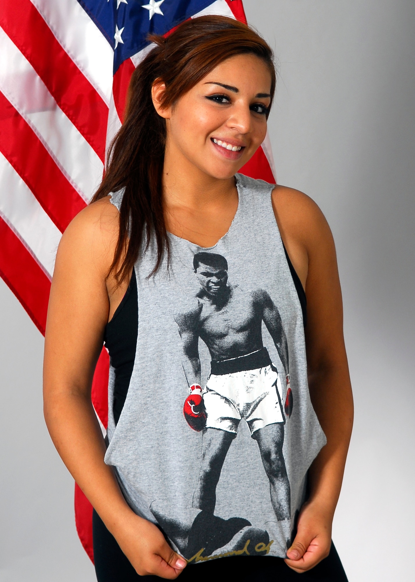 Airman 1st Class Elizabeth Roman, 56th Communications Squadron cyber transport systems technician, shows off her Muhammad Ali T-shirt, which to her represents an expression of determination and how a person with determination can overcome any obstacle. (U.S. Air Force photo/Airman 1st Class Pedro Mota)