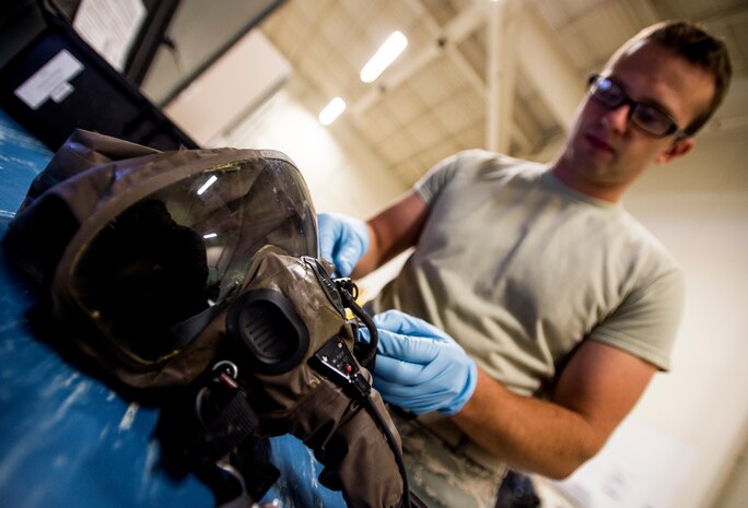 Airman 1st Class Nicholas Kanos, 437th Operations Support Squadron aircrew flight equipment technician, inspects a MDU-19mask used by C-17A Globemaster III aircrew members in the event of a chemical warfare attack Sep. 3, 2014, at Joint Base Charleston, S.C. Kanos checks the mask for any damaged parts or broken seals. (U.S. Air Force photo/Senior Airman Dennis Sloan)