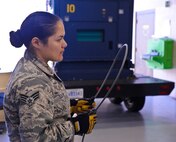 Senior Airman Nancy Teslich, 341st Maintenance Operation Squadron power, refrigeration, and electrical technician, inspects a guidance missile maintenance platform life support cable during a training session at Malmstrom Air Force Base’s 3-Bay Hangar Aug. 19. During inspection, every foot of the cable is closely examined to ensure there is no damage. (U.S. Air Force photo/Airman 1st Class Collin Schmidt)