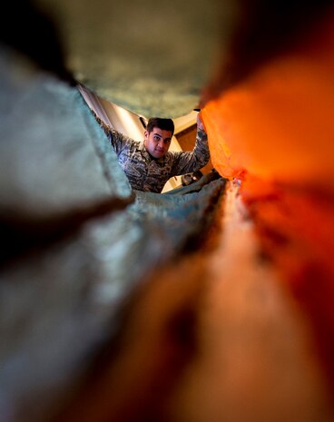 Senior Airman Brian Tiqui, 437th Operations Support Squadron aircrew flight equipment technician, prepares a parachute to be packed for use on a C-17A Globemaster III, Sep. 3, 2014, at Joint Base Charleston, S.C. The 437th OSS Airmen swap out and inspect equipment for C-17 alert aircraft every 30 days. (U.S. Air Force photo/Senior Airman Dennis Sloan) 