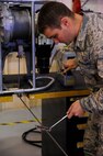 Senior Airman Justin Rollins, 341st Missile Maintenance Squadron facility maintenance technician, troubleshoots a guidance missile maintenance platform life support cable during a training session at Malmstrom Air Force Base’s 3-Bay Hangar Aug. 19. The cable must be routinely inspected to ensure there is no damage or frayed threads. (U.S. Air Force photo/Airman 1st Class Collin Schmidt)