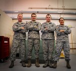 (From left to right) Tech. Sgt. Brian Dinkins, Senior Airman Justin Rollins, Airman 1st Class Robert Hawkins and Senior Airman Nancy Teslich, 341st Maintenance Operations Squadron power, refrigeration, and electrical section team, pose for a photograph after a training session at Malmstrom’s 3-Bay Hangar Aug. 19. The team is one of nine from Malmstrom Air Force Base that will be competing in the 2014 Air Force Global Strike Challenge. (U.S. Air Force photo/Airman 1st Class Collin Schmidt)