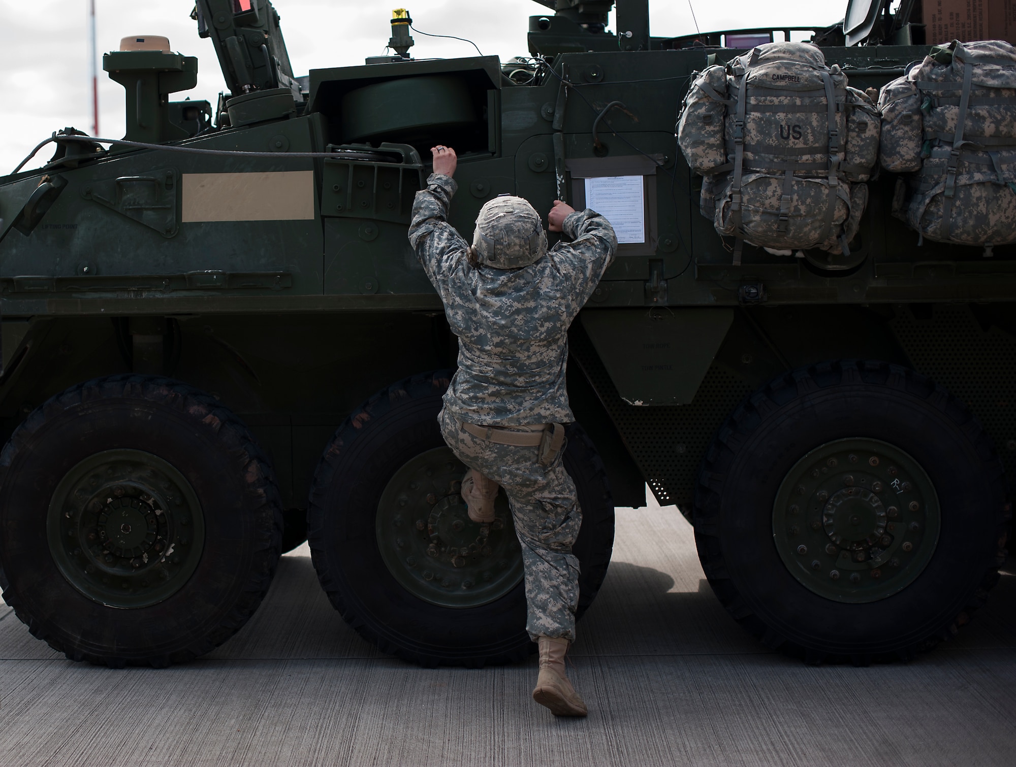 U.S. Army Troopers assigned to Apache Troop, 1st Squadron, 2d Cavalry Regiment adjust equipment on their Strykers during Steadfast Javilen II, Ramstein Air Base, Germany, Sept. 2, 2014. Steadfast Javelin II prepares U.S., NATO Allies and European security partners to conduct unified land operations through the simultaneous combination of offensive, defensive, and stability operations appropriate to the mission and the environment, and to sustain interoperability with partner nations. (U.S. Air Force photo/Senior Airman Damon Kasberg)