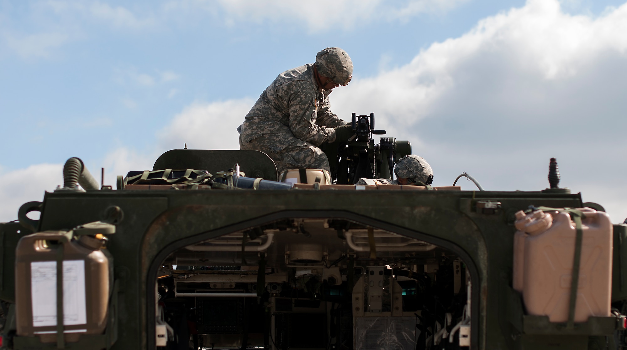 U.S. Army Troopers assigned to Apache Troop, 1st Squadron, 2d Cavalry Regiment adjust equipment on their Strykers during Steadfast Javilen II at Ramstein Air Base, Germany, Sept. 2, 2014. Steadfast Javelin II prepares U.S., NATO Allies and European security partners to conduct unified land operations through the simultaneous combination of offensive, defensive, and stability operations appropriate to the mission and the environment, and to sustain interoperability with partner nations. (U.S. Air Force photo/Senior Airman Damon Kasberg)