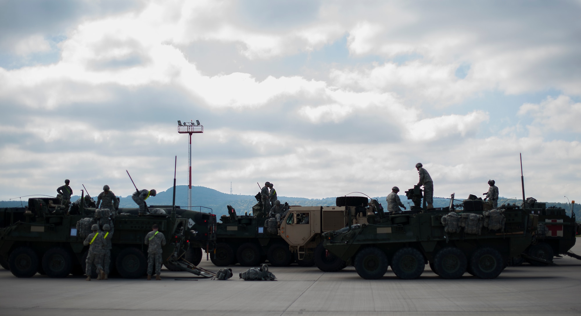 U.S. Army Troops assigned to Apache Troop, 1st Squadron, 2d Cavalry Regiment adjust equipment on their Strykers during Steadfast Javilen II at Ramstein Air Base, Germany, Sept. 2, 2014. The exercise, Steadfast Javelin II, features a number of dynamic events designed to challenge the multi-national forces in airborne operations, conventional warfare scenarios as well as stability and defensive operations, and support of civil authorities operations. (U.S. Air Force photo/Senior Airman Damon Kasberg)
